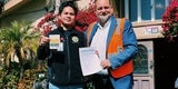 Two men holding immigrant inclusion survey. 