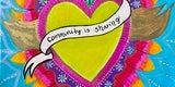 Yellow heart with ribbon that reads Community is Sharing