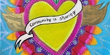 Yellow heart with ribbon that reads Community is Sharing