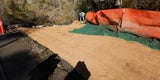 AGI’s subcontractor installing an erosion control blanket over the newly sprayed BFM