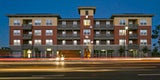 Peninsula Station affordable housing is a modern building at night
