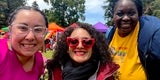 Supervisor Corzo is smiling next to two friends at the Pride Festival.