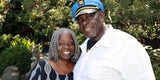 A photo of a San Mateo County Resource Family. The couple are smiling. 