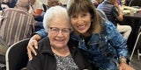 two women smiling at camera