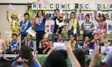 Group of school kids waving handmade flags