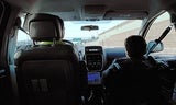 View of the back of a driver and passenger