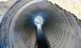 A culvert running under a dirt road