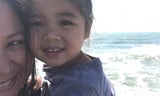 Christine Padilla and her daughter with the ocean behind them.