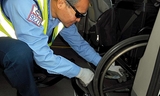Man setting the brake on a wheelchair