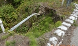 Eroded embankment and exposed telecommunication line