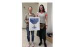 Artist stands with her painting featuring blue clouds emerging from a woman's mind, heart, and body