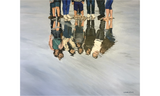 Teens standing in a puddle of water, with their reflections visible in the water