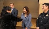 Well-being Academy graduate shaking hands with leadership