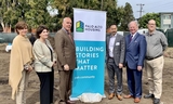 Stakeholders posing with Palo Alto Housing's Building Stories That Matter sign