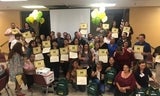 graduates posing with certificates