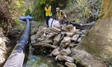 AGI install a temporary creek diversion system and remove existing sacked concrete wall from the creek