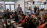 Adam Ely leads a video briefing in the Emergency Operations Center