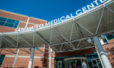 San Mateo Medical Center sign above front entrance against a clear blue sky