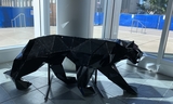 Shiny black lion statue made of recycled materials
