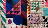 Brightly colored patchwork quilt close up