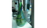 Green glass vase with blue swirl