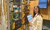 A member of the ISD VOIP team poses in the server room