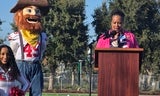 Sup. Gauthier addresses crowd, 49ers mascot Sourdough Sam nearby