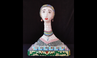 A woman's face, head, neck and shoulders made from colorful mosaic tile featuring blues and greens