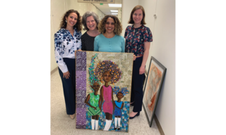 Artist Rebecca Archer stands with her friends as she shows off her Best In Show painting, Unbreakable, which features 3 Black girls.