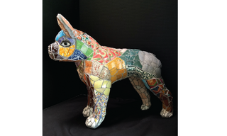 Small dog made out of colorful mosaic pieces in red, orange, green and gray