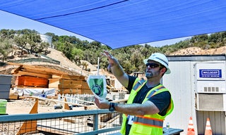 Scott Gurley, the project manager, describes what the new campus will look like based off of renderings in his hand.