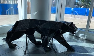 Shiny black lion statue made of recycled materials