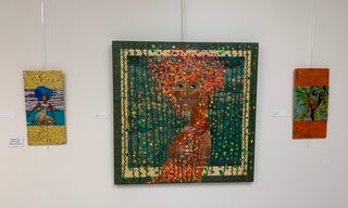 A large green and orange collage of a Black woman
