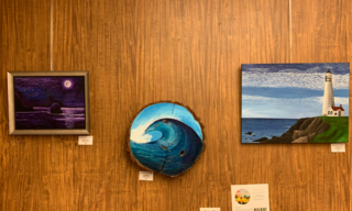 3 paintings, purple night sky and moon (left), blue wave woodcut (middle) blue sky and white lighthouse (right)