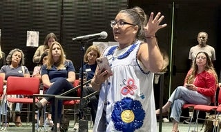 woman at mic, gesturing