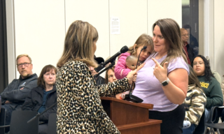 mom with daughter speaking at podium