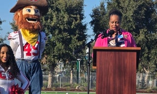 Sup. Gauthier addresses crowd, 49ers mascot Sourdough Sam nearby