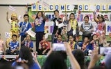 Group of school kids waving handmade flags