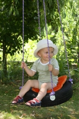 Child on tire swing