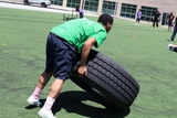 kid rolling a tire