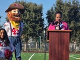 Sup. Gauthier addresses crowd, 49ers mascot Sourdough Sam nearby