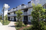 Multi-story sustainable building that houses residents experiencing homelessness.