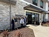 four people at building entrance