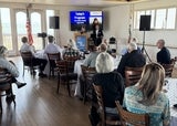 group of people listening to a speaker