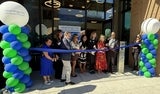 group of people cutting ribbon