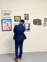 man looking at art