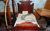 This original 1860s doll bed adorns a bedroom in the Lathrop House. Furniture, fixtures, tools and books throughout the home date from the late 1800s.