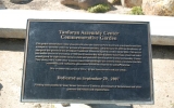 This plaque, located at the front of The Shops at Tanforan, was dedicated in September 2007 to memorialize those who lived under armed guard at the former Tanforan race track.