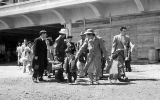 Families arrive at the Tanforan Assembly Center in this Dorothea Lange photograph from April 1942 taken for the War Relocation Authority.