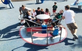Taking a spin at the Magical Bridge playground in Palo Alto.